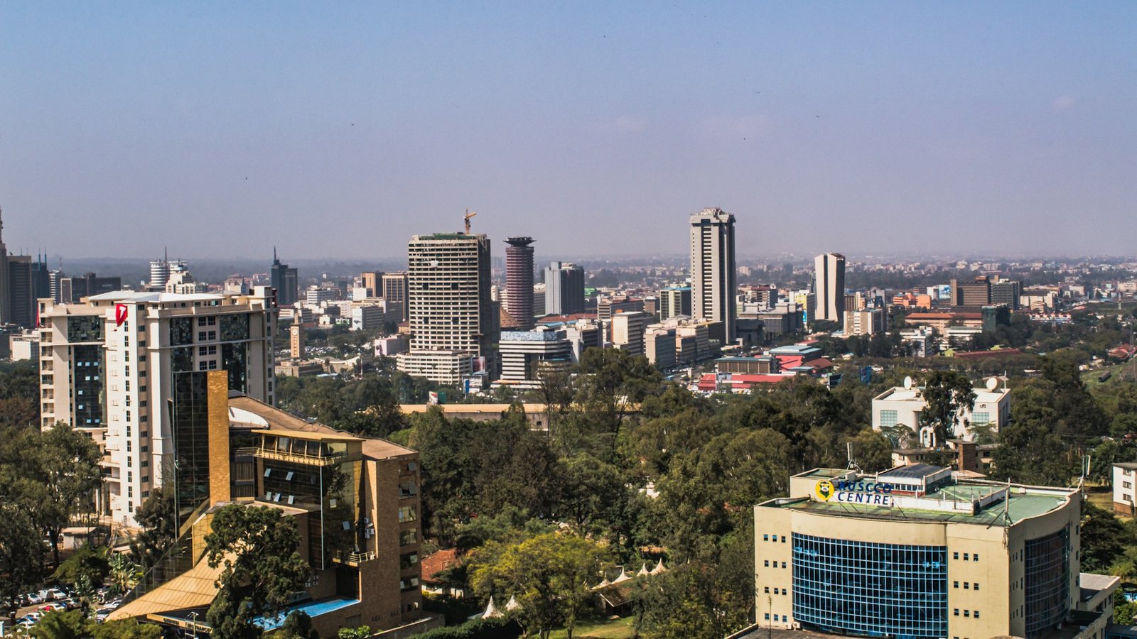 The Nairobi skyline on a sunny day: modern office towers rising above green parkland