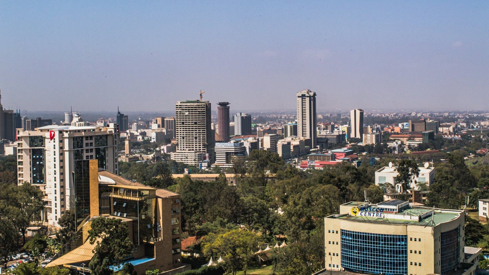 The Nairobi skyline on a clear day, office towers rising above green trees
