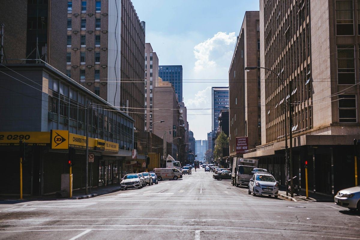 A street between tall office buildings in central Johannesburg