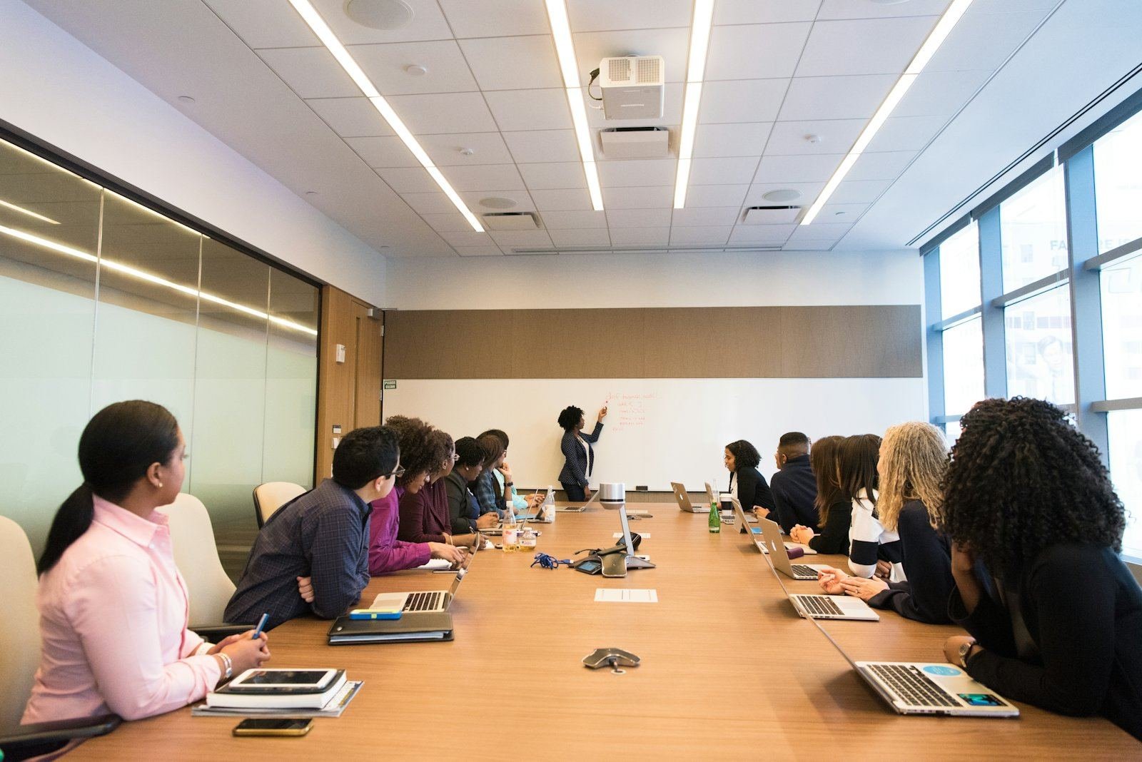 Colleagues seated along a boardroom table during a presentation